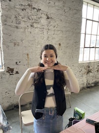 a woman is posing for a picture in front of a table