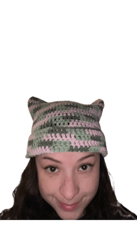 a woman wearing a crocheted cat hat