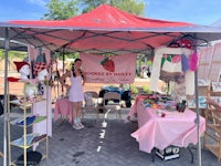 a woman standing under a tent