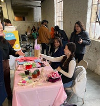 a group of people standing around a table