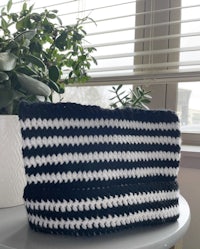 a black and white crocheted basket sitting on top of a table