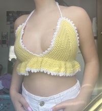 a woman wearing a yellow crocheted bikini top