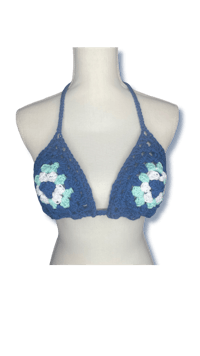 a blue crochet bikini top with flowers on it