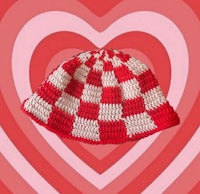 a crocheted hat with a red and white checkered pattern