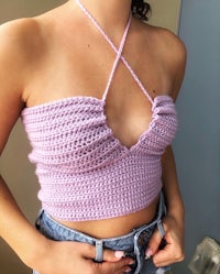 a woman wearing a purple crocheted top