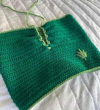 a green crocheted top with a marijuana leaf on it